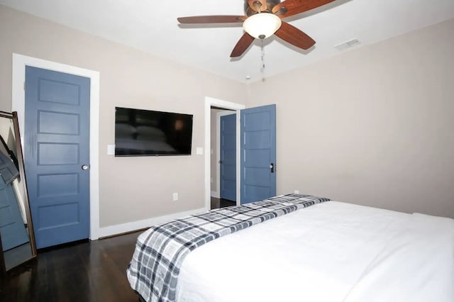 4434 Leeland St, Houston, TX 77023 - bedroom with dark wood-style flooring, baseboards, and a ceiling fan