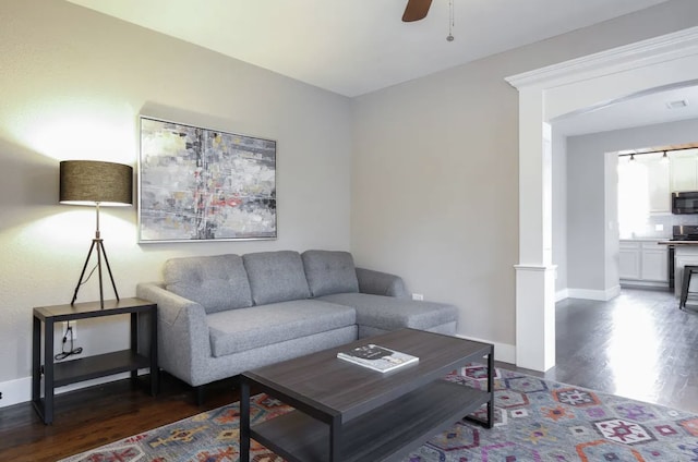 4434 Leeland St, Houston, TX 77023 - living room with wood finished floors, a ceiling fan, and baseboards