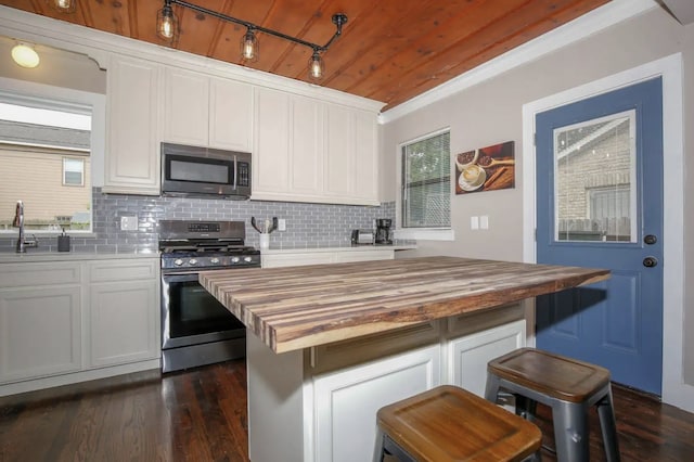 4434 Leeland St, Houston, TX 77023 - kitchen with appliances with stainless steel finishes, wood counters, a sink, backsplash, and wood ceiling