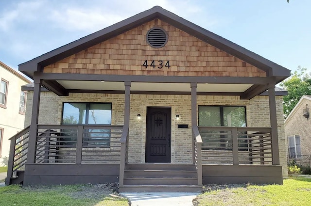 4434 Leeland St, Houston, TX 77023 - view of front of house featuring a porch and brick siding
