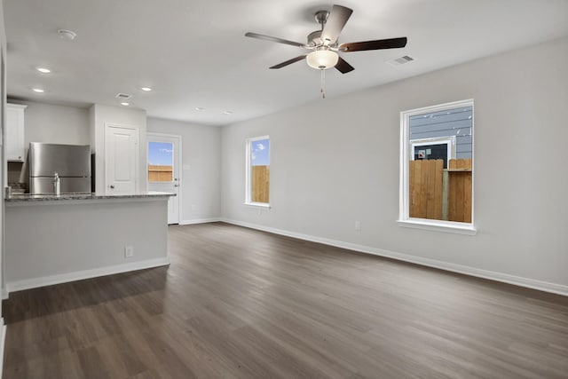 15842 Berry Hill Dr, Conroe, TX 77303 - unfurnished living room featuring dark wood finished floors, baseboards, ceiling fan, and recessed lighting