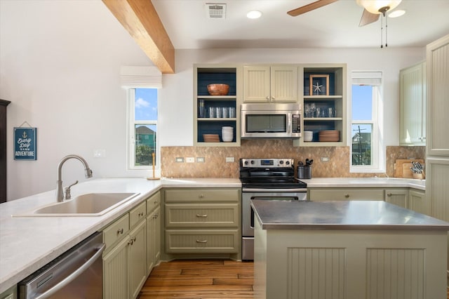 2932 Lakeside Dr, Crystal Beach, TX 77650 - kitchen featuring appliances with stainless steel finishes, a sink, open shelves, tasteful backsplash, and dark wood finished floors