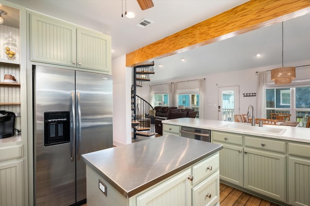 2932 Lakeside Dr, Crystal Beach, TX 77650 - kitchen featuring stainless steel appliances, stainless steel countertops, a sink, green cabinets, and beam ceiling