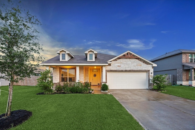 310 Morning Dove Trl, Sealy, TX 77474 - view of front of house featuring stone siding, an attached garage, and concrete driveway