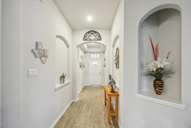 310 Morning Dove Trl, Sealy, TX 77474 - doorway to outside featuring light wood-type flooring, baseboards, arched walkways, and recessed lighting