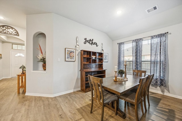 310 Morning Dove Trl, Sealy, TX 77474 - dining room featuring light wood finished floors, baseboards, vaulted ceiling, arched walkways, and recessed lighting