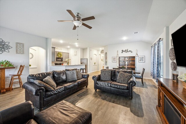 310 Morning Dove Trl, Sealy, TX 77474 - living area featuring arched walkways, ceiling fan, wood finished floors, baseboards, and recessed lighting