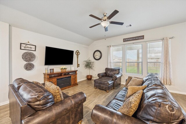 310 Morning Dove Trl, Sealy, TX 77474 - living room with baseboards, lofted ceiling, a ceiling fan, wood finished floors, and a glass covered fireplace