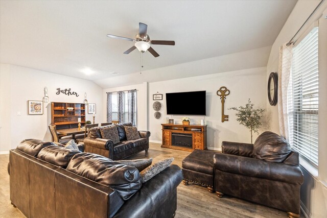 310 Morning Dove Trl, Sealy, TX 77474 - living room featuring a ceiling fan, wood finished floors, baseboards, and vaulted ceiling