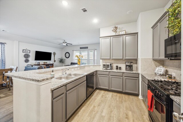 310 Morning Dove Trl, Sealy, TX 77474 - kitchen featuring black appliances, gray cabinetry, a sink, a peninsula, and a ceiling fan