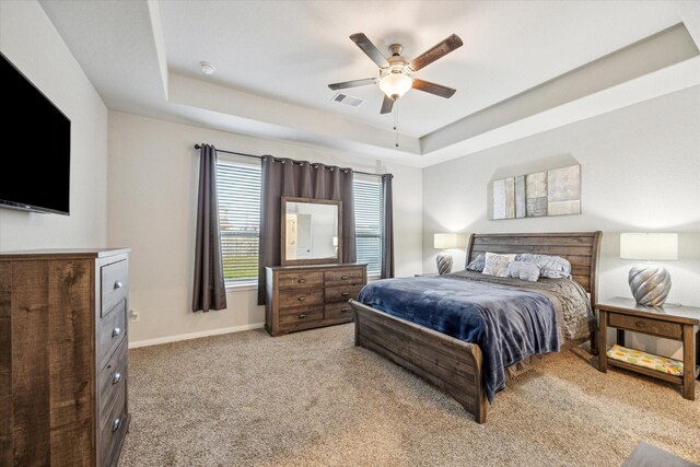 310 Morning Dove Trl, Sealy, TX 77474 - bedroom with a tray ceiling, light colored carpet, ceiling fan, and baseboards