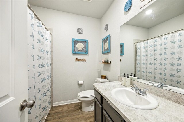 310 Morning Dove Trl, Sealy, TX 77474 - bathroom featuring wood finished floors, toilet, baseboards, and vanity