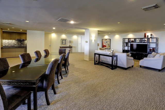 dining room featuring light colored carpet and recessed lighting