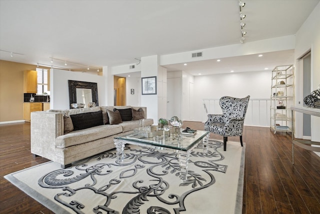 living area featuring track lighting and dark wood finished floors