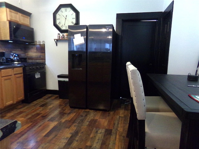 413 Paulus St, Schulenburg, TX 78956 - kitchen with black appliances, dark wood-style flooring, and dark countertops
