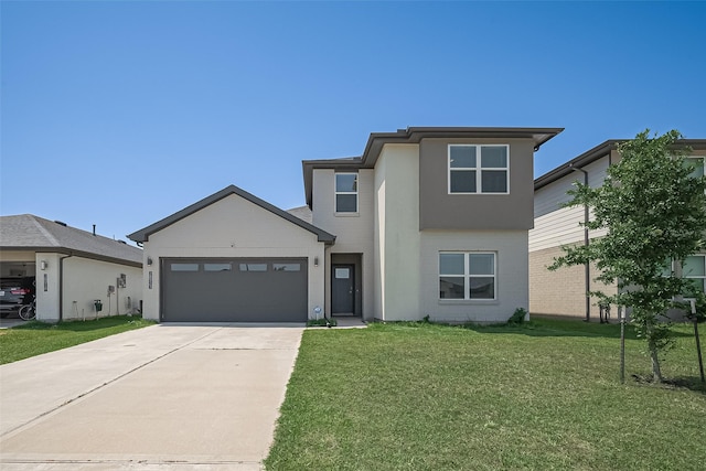 28923 Yukon River Ct, Katy, TX 77494 - view of front facade with an attached garage, concrete driveway, a front lawn, and stucco siding