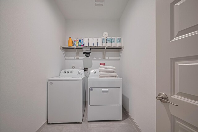 28923 Yukon River Ct, Katy, TX 77494 - laundry area with separate washer and dryer, baseboards, and light tile patterned floors