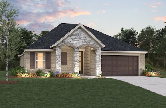 3217 21st St N, Texas City, TX 77590 - view of front of property featuring a garage, driveway, a yard, stone siding, and brick siding