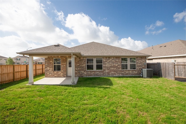 3217 21st St N, Texas City, TX 77590 - rear view of property featuring a patio, brick siding, cooling unit, and roof with shingles