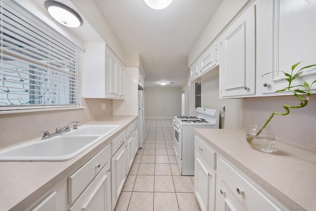 9215 Linda Vista Rd, Houston, TX 77078 - kitchen with white appliances, a sink, light countertops, and light tile patterned floors