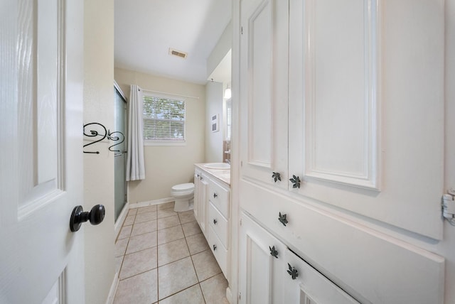 9215 Linda Vista Rd, Houston, TX 77078 - full bathroom featuring vanity, tile patterned floors, an enclosed shower, toilet, and baseboards