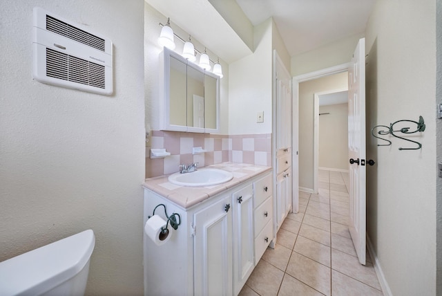 9215 Linda Vista Rd, Houston, TX 77078 - bathroom featuring backsplash, a wall mounted AC, tile patterned floors, toilet, and vanity