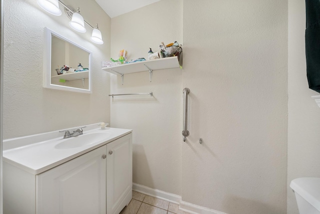 9215 Linda Vista Rd, Houston, TX 77078 - half bathroom with vanity, tile patterned flooring, toilet, and baseboards