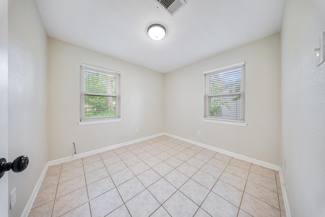 9215 Linda Vista Rd, Houston, TX 77078 - unfurnished room featuring plenty of natural light, light tile patterned floors, and baseboards