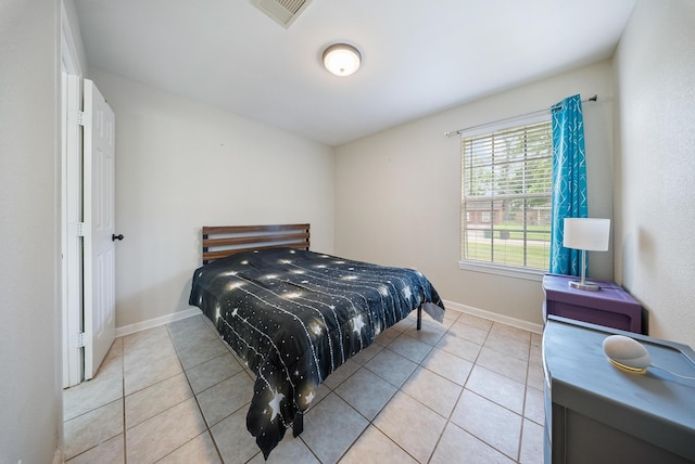 9215 Linda Vista Rd, Houston, TX 77078 - bedroom with light tile patterned floors and baseboards