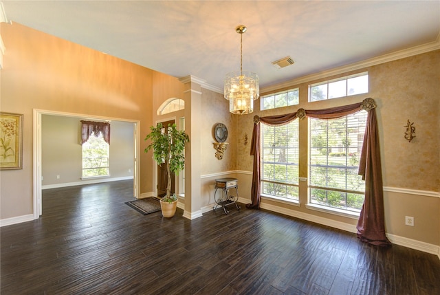 7610 Cedar Jump Dr, Humble, TX 77346 - unfurnished dining area featuring plenty of natural light, a chandelier, wood finished floors, baseboards, and ornamental molding