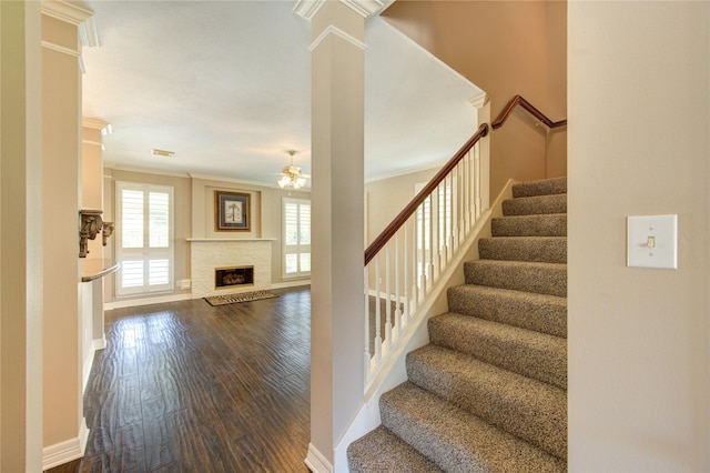 7610 Cedar Jump Dr, Humble, TX 77346 - stairway with ceiling fan, wood finished floors, crown molding, a fireplace, and baseboards