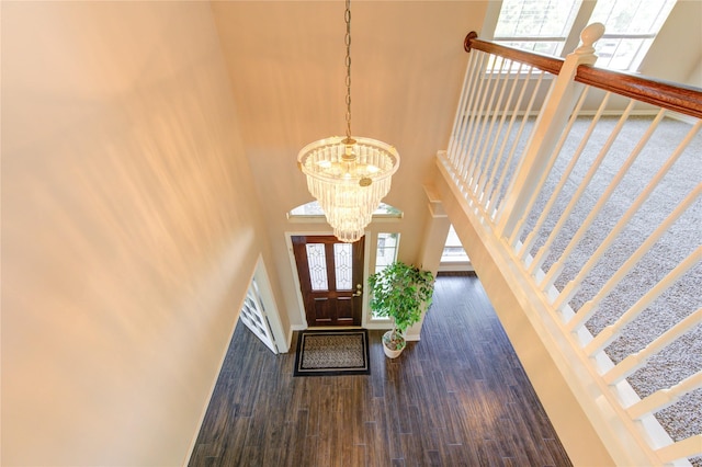 7610 Cedar Jump Dr, Humble, TX 77346 - foyer featuring a towering ceiling, stairs, a chandelier, wood finished floors, and baseboards