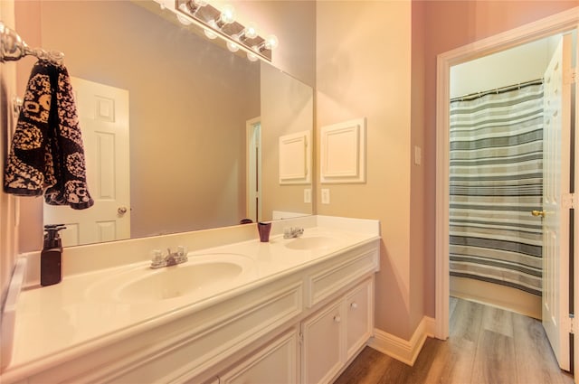 7610 Cedar Jump Dr, Humble, TX 77346 - full bath with wood finished floors, double vanity, baseboards, and curtained shower