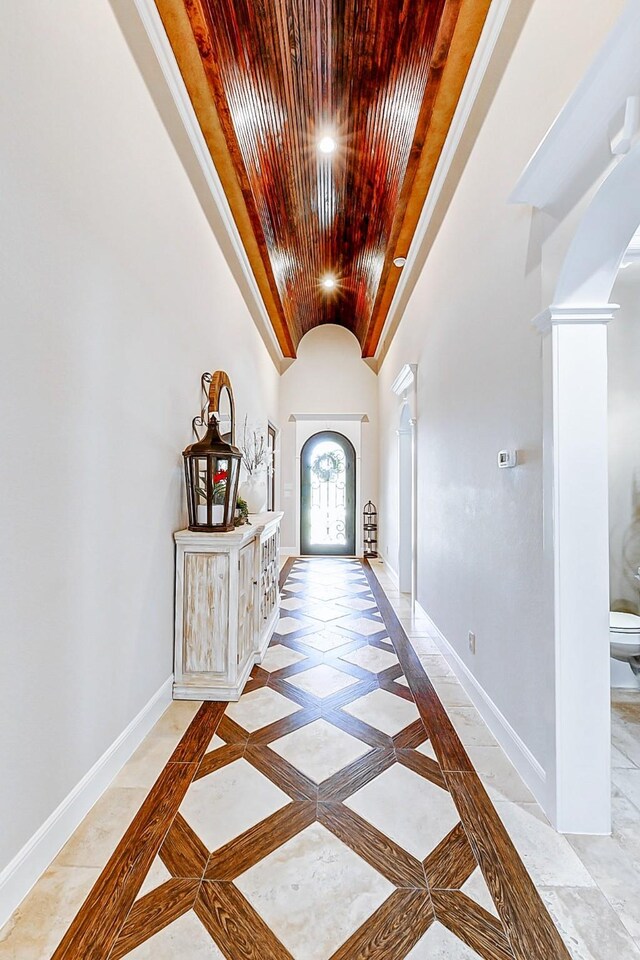 32811 Warbler Ct, Fulshear, TX 77441 - foyer entrance with wooden ceiling, arched walkways, decorative columns, vaulted ceiling, and baseboards