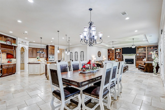 32811 Warbler Ct, Fulshear, TX 77441 - dining area with ceiling fan, recessed lighting, stone tile flooring, a chandelier, and a fireplace