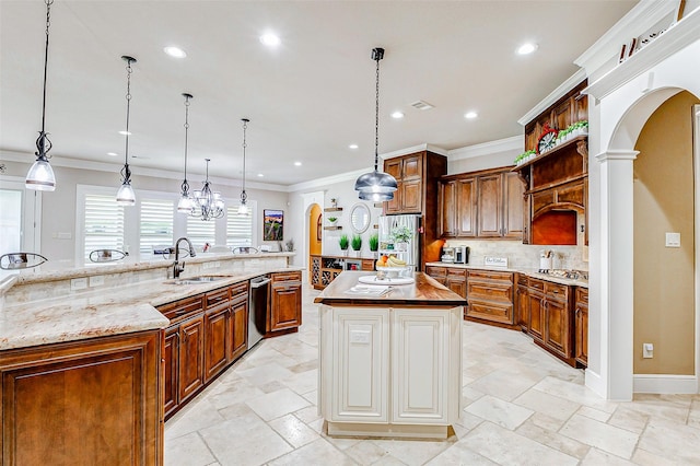 32811 Warbler Ct, Fulshear, TX 77441 - kitchen with a large island with sink, a sink, arched walkways, stainless steel appliances, and recessed lighting