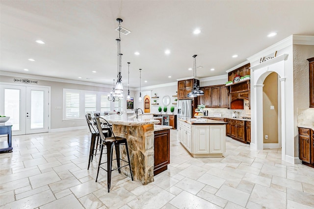 32811 Warbler Ct, Fulshear, TX 77441 - kitchen with a spacious island, recessed lighting, decorative backsplash, crown molding, and baseboards