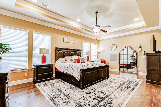 32811 Warbler Ct, Fulshear, TX 77441 - bedroom featuring a raised ceiling, ornamental molding, light wood-style flooring, baseboards, and recessed lighting
