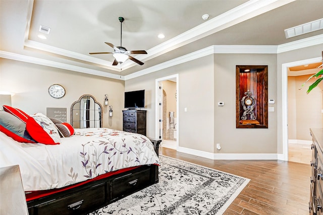 32811 Warbler Ct, Fulshear, TX 77441 - bedroom featuring ornamental molding, baseboards, a tray ceiling, light wood-style floors, and recessed lighting