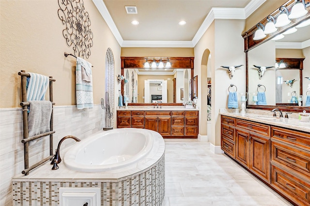 32811 Warbler Ct, Fulshear, TX 77441 - bathroom featuring two vanities, ornamental molding, and a tub with jets