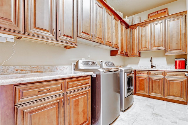 32811 Warbler Ct, Fulshear, TX 77441 - washroom featuring cabinet space, washer and clothes dryer, and light stone finish floors