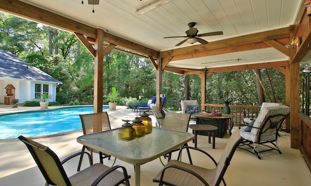 20103 Diamond Ct, Magnolia, TX 77355 - view of patio / terrace with ceiling fan, an outdoor pool, and outdoor dining area