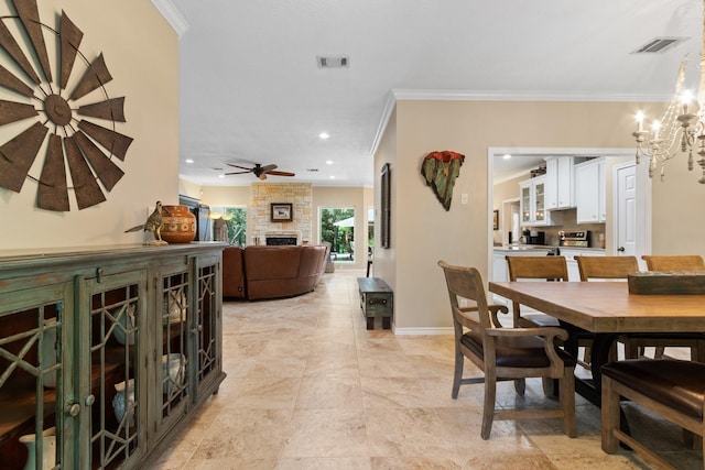 20103 Diamond Ct, Magnolia, TX 77355 - dining room featuring ornamental molding, a fireplace, a chandelier, baseboards, and a ceiling fan
