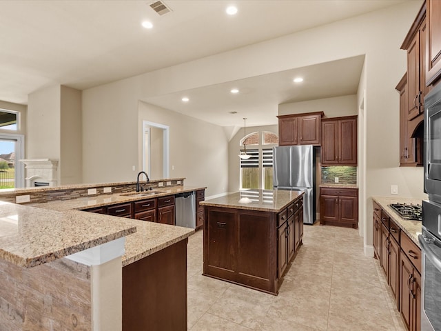 4410 Cobalt Cross St, Katy, TX 77493 - kitchen with appliances with stainless steel finishes, a large island, a sink, plenty of natural light, and recessed lighting