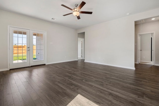 unfurnished living room with attic access, a ceiling fan, dark wood-type flooring, and baseboards
