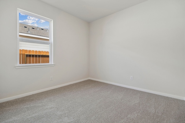 spare room with carpet flooring and baseboards