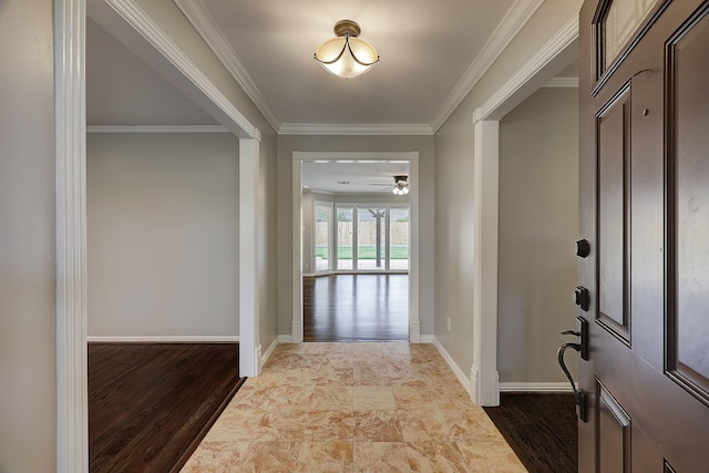 foyer entrance featuring crown molding, ceiling fan, baseboards, and dark wood-style flooring