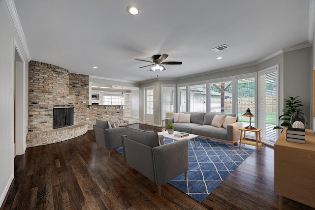 living room featuring a ceiling fan, wood finished floors, ornamental molding, a brick fireplace, and recessed lighting