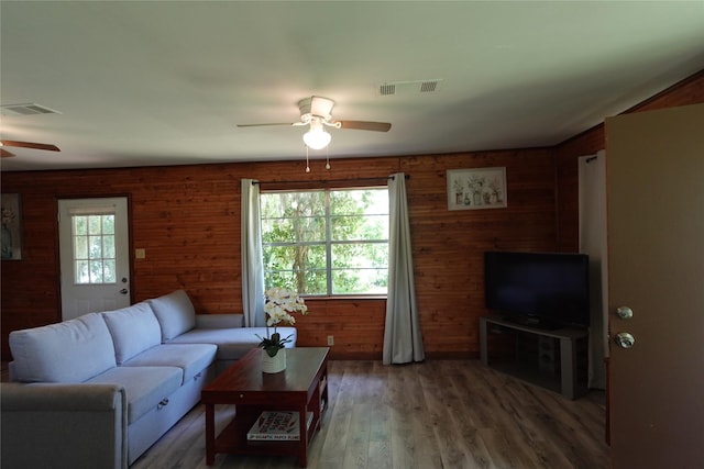 215 Weldon, Livingston, TX 77351 - living area featuring ceiling fan, light wood-style flooring, and wood walls
