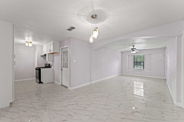6105 Arthington St, Houston, TX 77053 - unfurnished living room with a textured ceiling, light marble finish flooring, a ceiling fan, baseboards, and arched walkways